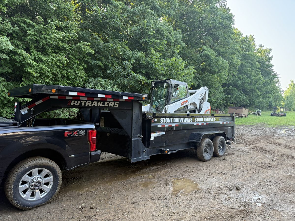 T&R Land Pros truck and dump trailer hauling stone